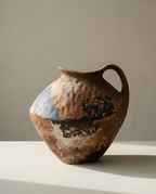 Handled Stoneware Vase, an asymmetric jug form with rust, slate and black patchwork glaze and an arched handle