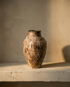 Taishi Clay Vase with a dimpled brown and cream glaze in an amphora silhouette, on a plaster shelf
