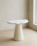 Cloud Side Table with a glossy cream irregular top on a single conical pedestal base, on pale oak flooring