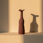 Tall slim burgundy bottle vase with a flared lip