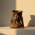 Crumpled stoneware vase glazed rust and blue-black over the creases