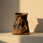 Crumpled stoneware vase glazed rust and blue-black over the creases