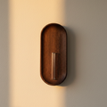 Walnut wall-mounted bud vase with a slim glass tube