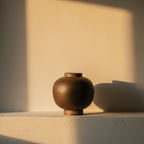 Round squat stoneware pot in a dry dark matte glaze