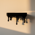 Black wall shelf with an underside melting away in long drips