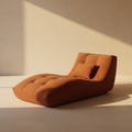 Low burnt orange corduroy chaise lounge at floor level