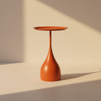 Burnt orange side table on a flared teardrop stem