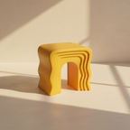 Yellow moulded stool cut into stacked waves