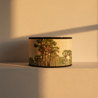 Drum lampshade printed with palm trees, shown on its own