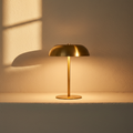 Brass dome table lamp lit, casting a warm pool of light