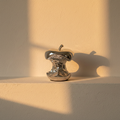 Mirror-polished silver apple core sculpture