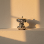 Mirror-polished silver apple core sculpture