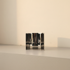 Mirror-polished steel sculpture folded into vertical ripples