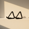 A pair of matte black triangular bookends