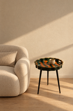Scalloped tray table with removable top beside a linen armchair