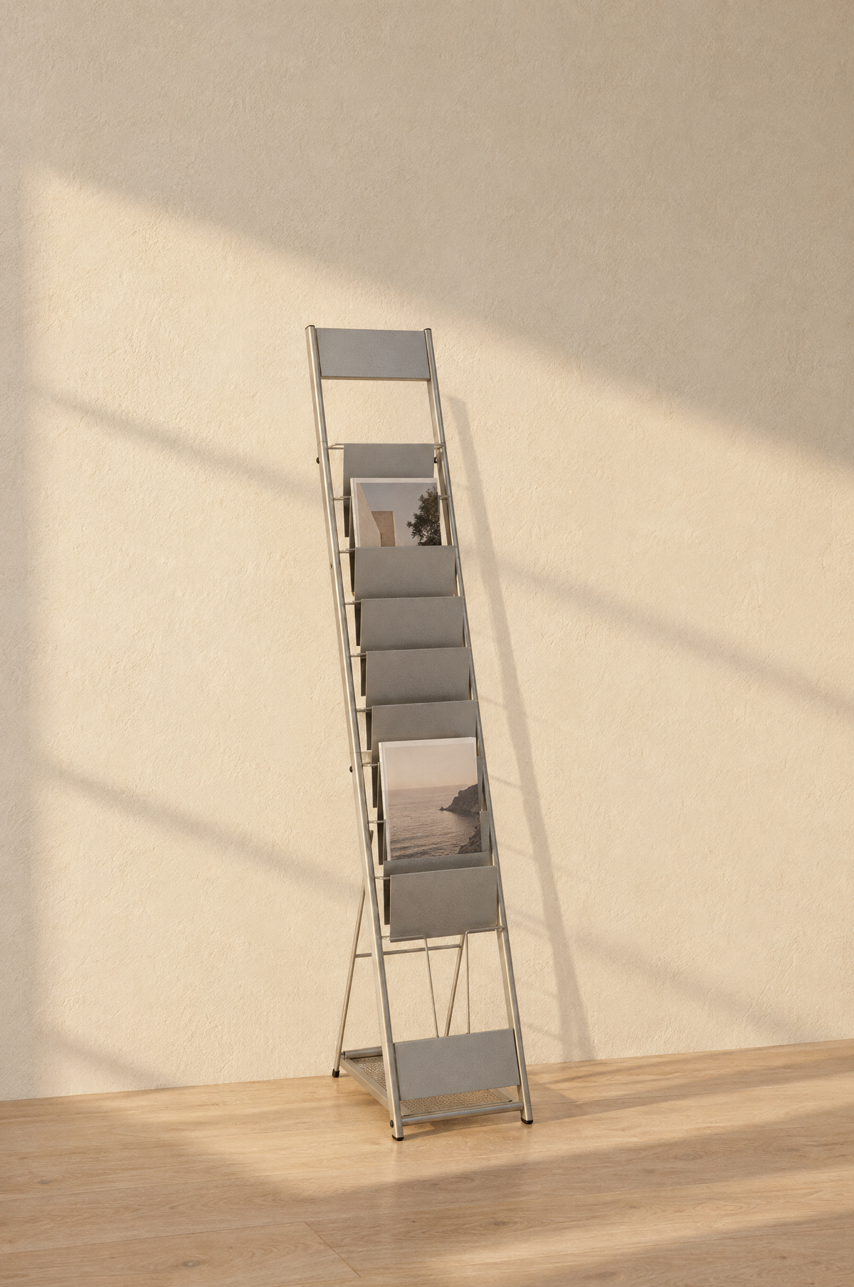 Freestanding steel magazine rack against a plaster wall