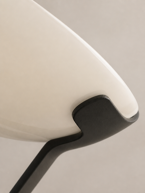 Close-up of the cream acrylic shell meeting the dark base
